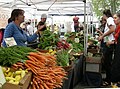 A vegetable vendor in a marketplace. (from Economics)