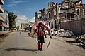 Image 13A man carries a huge hammerhead shark through the streets of Mogadishu