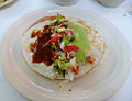 A sincronizada made ham, oaxaca cheese, topped with chipotle & green salsas, plus pico de gallo.