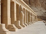 A line of statue bases, many with partial stone statues