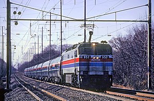Locomotive with a raised pantograph and nine cars trailing