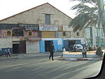 An industrial building with some people in front