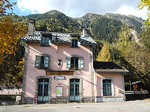 Pink three-story building with gabled roof