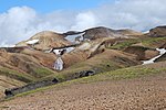 Kaldaklofsfjöll panorama, rhyolitic rocks with snow and sparse vegetation