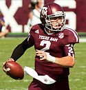 A picture of Johnny Manziel while holding the football during a game.