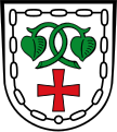 Gemeinde Warngau In Silber unter zwei grünen Seeblättern, an verschlungenen Stielen, ein rotes Kreuz, umgeben von einer dem Schildrand folgenden schwarzen Kette.