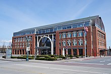 A four-story building with a prominent arch at the front entrance