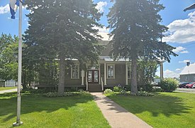 View of the front facade of the town hall, located next to the church