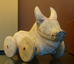 A buffalo figurine with wheels