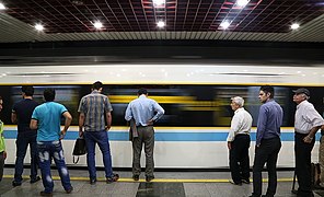 Passengers wait to board a train in 2018