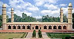 A large decorated mausoleum with four minarets