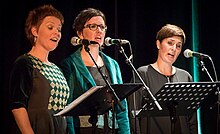 The trio at stage at a concert in 2016