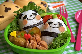 An oekakiben containing rice balls decorated with nori to resemble pandas