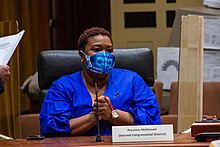 Precious McKesson sitting at a desk, with her hands clasped in front of her, during the signing of the Electoral Vote for President Joseph R. Biden and Vice President Kamala Harris on December 13, 2020, in Lincoln, Nebraska