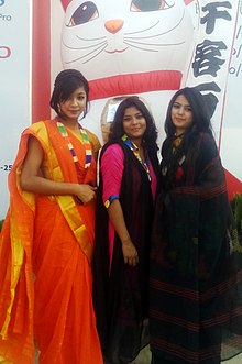 three women wearing saris
