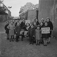 Welsh children with their Guy Fawkes effigy in November 1962. The sign reads "Penny for the Guy".