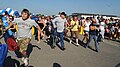 Audience members rush toward the stage after the gates open at an Army Concert Tour stop at Fort Knox.