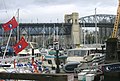 View of Kitsilano and central spans of Burrard Bridge, from dock level, marina, southwest quadrant