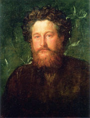 Fond vert, homme trentaine, visage en pleine lumière, cheveux abondants, courte barbe.