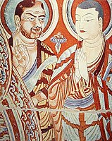 A blue-eyed Central Asian monk teaching an East-Asian monk, Bezeklik, Turfan, eastern Tarim Basin, China, 9th century; the monk on the right is possibly Tocharian,[144] although more likely Sogdian.[145][146]