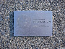 Stainless steel plaque showing fountain redesign was performed by WET Design using nozzles patented in 1988 and 1989 (US patents 4,978,066 and 4,852,801)