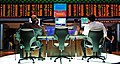Two traders sit at computer monitors with financial information. (from Economics)