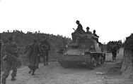 An L6/40 with German markings passes German infantrymen in occupied Albania, September 1943.
