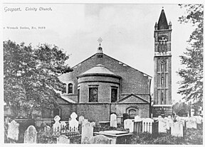 A black and white photograph of Holy Trinity's churchyard in circa 1904, when the tombstones were still there.