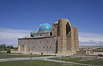 A large brick mausoleum with blue domes