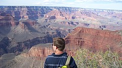 View from southwest, (5.5-mi distant, from Pima Point, South Rim) 2-prominences, Isis Temple, separated from Buddha Temple-(and Buddha Cloister) by Phantom Creek (canyon) between Flat-topped Shiva Temple-(1.5-mi NW, same elevation as Kaibab Plateau), at photo left (note thicker unit of white, Coconino Sandstone, because of closer distance to viewpoint)