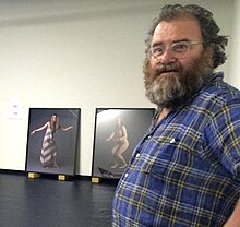 Robert Leonard setting up the exhibition 'Yvonne Todd: Creamy Psychology', 2014