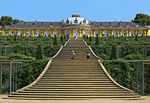 Single story pale yellow ornate palace stretching from the left foreground to the right background.