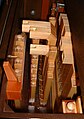 Each hole is connected to a valve in the interior of the organ which operates the organ pipes such as these wooden ones.