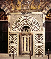 Mihrab of the mausoleum of Baybars, with marble mosaic paneling and glass mosaics above.