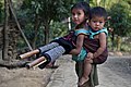 Image 56In Bangladesh there are many tribal people live in Sylhet, Dinajpur, Cox's Bazar, Mymensingh, Rajshahi etc. But majority of tribal people live in the Chittagong Hill Tracts. This picture features a tribal kid with her little sister tied in her back at Farukpara, Bandarban, Bangladesh. Photo Credit: Mohammad Rakibul Hasan