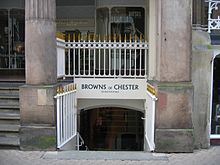 Two columns with a railing between, under which is a stairway leading from the street to a lower level