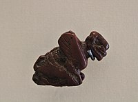 A red jasper carving of a squatting Pazuzu, the crouching posture suggesting his connection to the West Wind.[12]