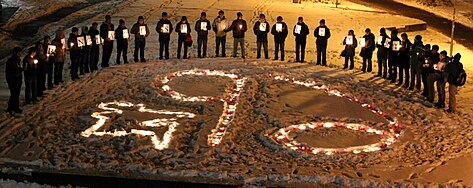 Semicircle of demonstrators holding candlelight vigil