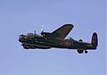 Color image of a Lancaster displaying its scheme: upper carriage in camouflage, undercarriage, sides and underwings flat black