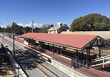 Brick platform with roof viewed from pedestrian overpass