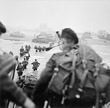 Men wading ashore from a landing craft