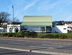 The pavilion; a white building with a green roof