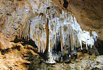 Column and array of stalactites in a cave.