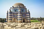 A mausoleum with a dome, facade decorated with blue tiles