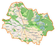 Mapa konturowa gminy Żmigród, blisko centrum na dole znajduje się punkt z opisem „Pałac w Żmigrodzie”