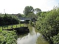 View of Sheepwash Channel, with the site of the old swing bridge in the foreground and the newer railway bridge in the background.