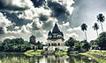 Image 53The pictured Shiva Temple is situated in Puthia Bazar of Rajshahi District. It was built on a hing plinth on the southern bank of a large tank. The temple is a 19.81 meter square building and total height is 35.03 meter. It is a Pancha Ratna type building consists of a Garbhagriha and a surrounding verandah. Rani Bhubanmoye Debi built this temple in 1823 AD. Photo Credit: Nasir Khan Saikat