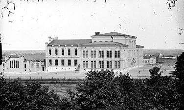 Katedralskolans huvudbyggnad från sydväst, med den nu rivna idrottshallen till vänster. Fotot är taget någon gång innan 1914.