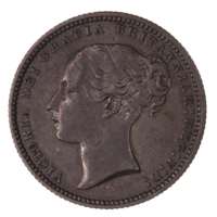 A British shilling, featuring Queen Victoria.