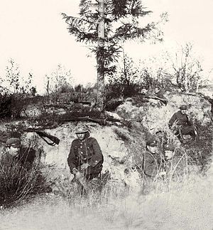 A group of six soldiers in Polish Army's uniforms in a trench